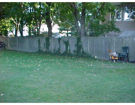 24 Thistle Road Woburn, MA 01801 - Photo 6 of 9 a backyard of a house with table and chairs