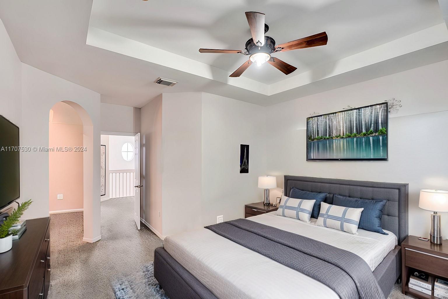 11763 Southwest 137th Path Miami, FL 33186 - Photo 11 of 27 a bedroom with a bed and a chandelier