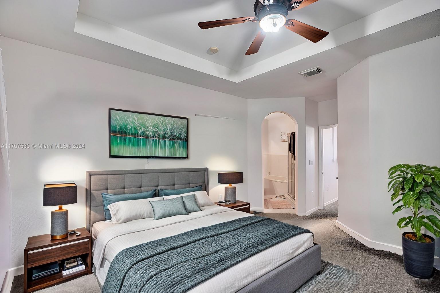 11763 Southwest 137th Path Miami, FL 33186 - Photo 12 of 27 a bedroom with a bed and a chandelier