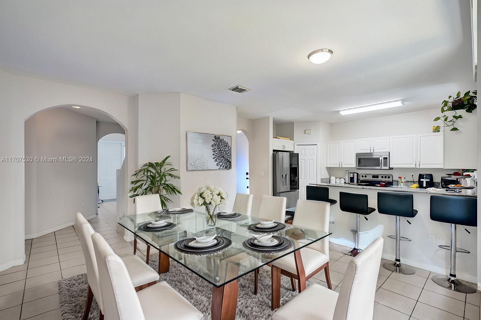11763 Southwest 137th Path Miami, FL 33186 - Photo 14 of 27 a view of a dining room with furniture and wooden floor