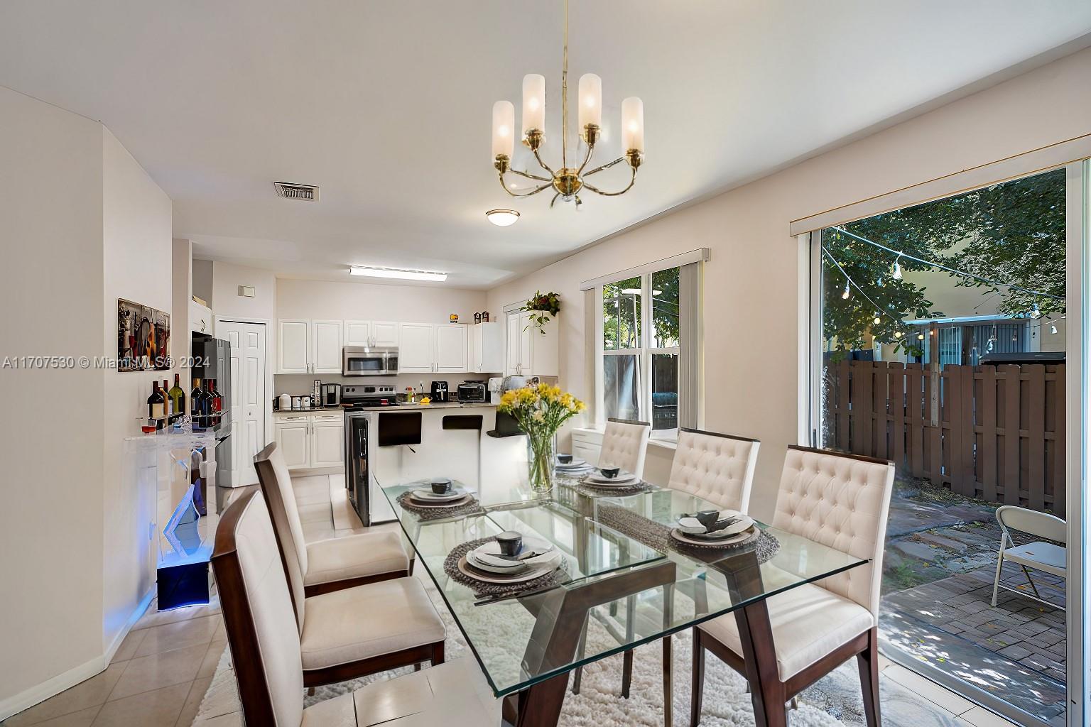 11763 Southwest 137th Path Miami, FL 33186 - Photo 15 of 27 a view of a dining room with furniture window and outside view