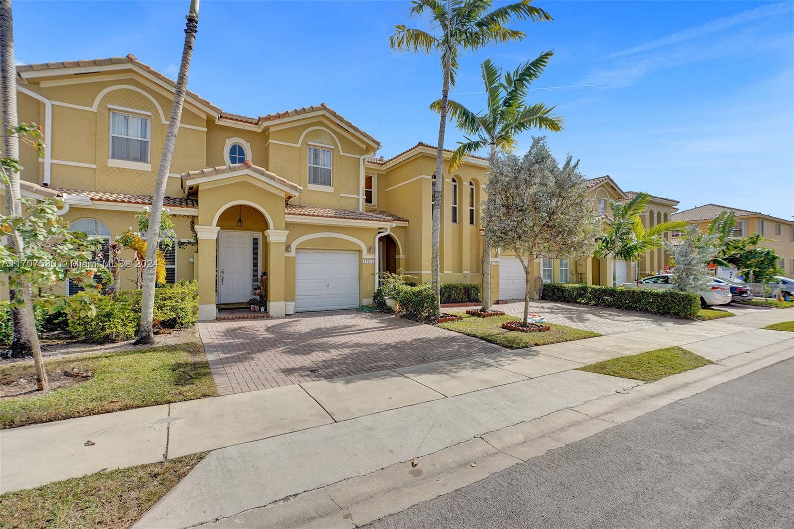 11763 Southwest 137th Path Miami, FL 33186 - Photo 2 of 27 a front view of a house with a yard and garage