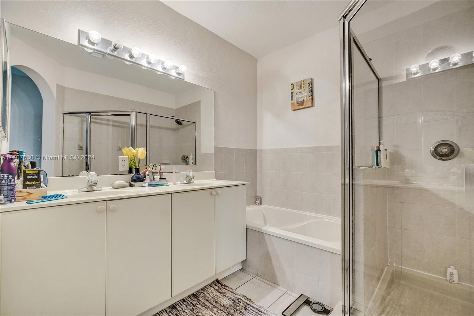 11763 Southwest 137th Path Miami, FL 33186 - Photo 21 of 27 a bathroom with a tub a sink and mirror