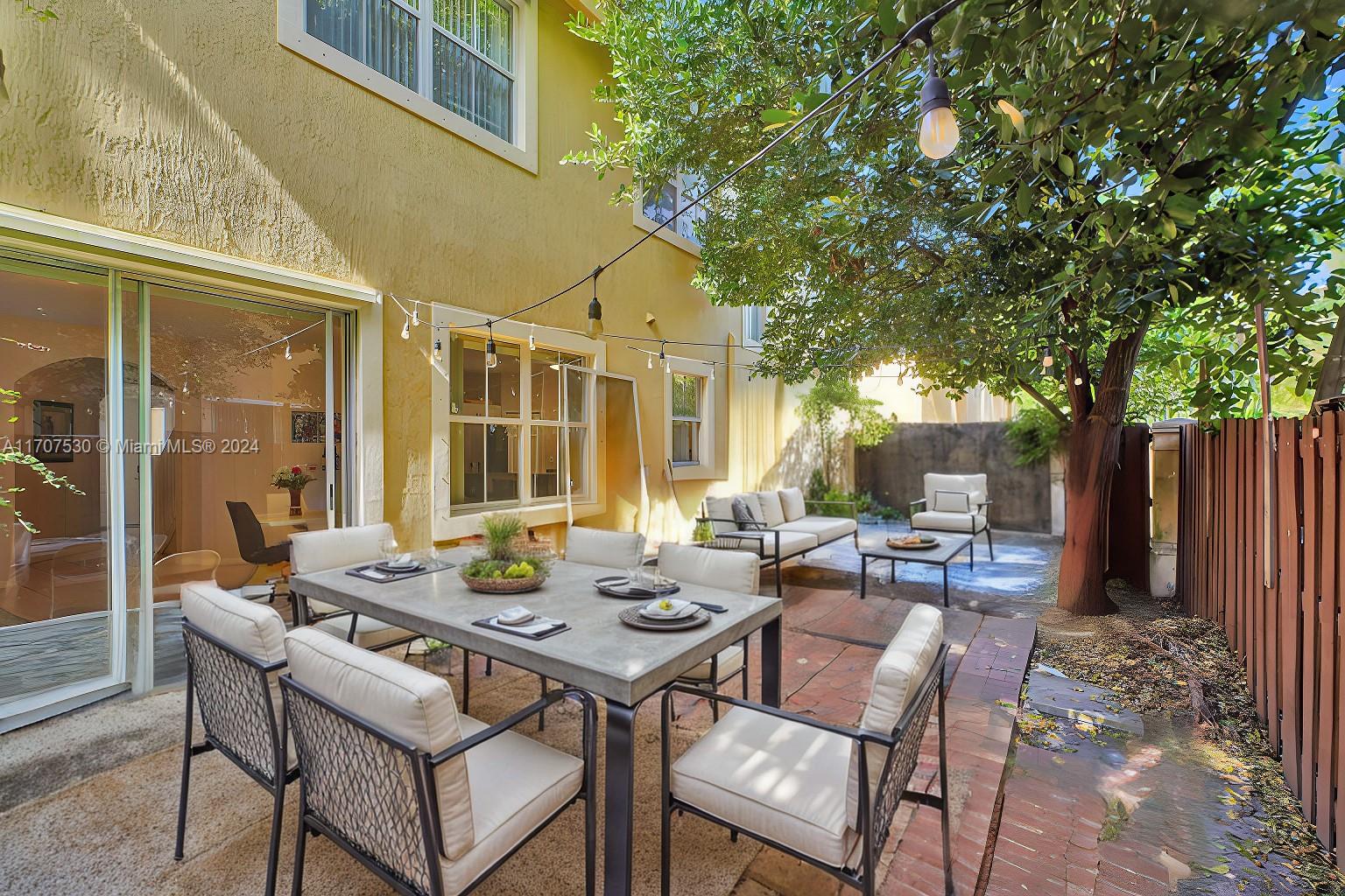 11763 Southwest 137th Path Miami, FL 33186 - Photo 23 of 27 a backyard of a house with a table and chairs