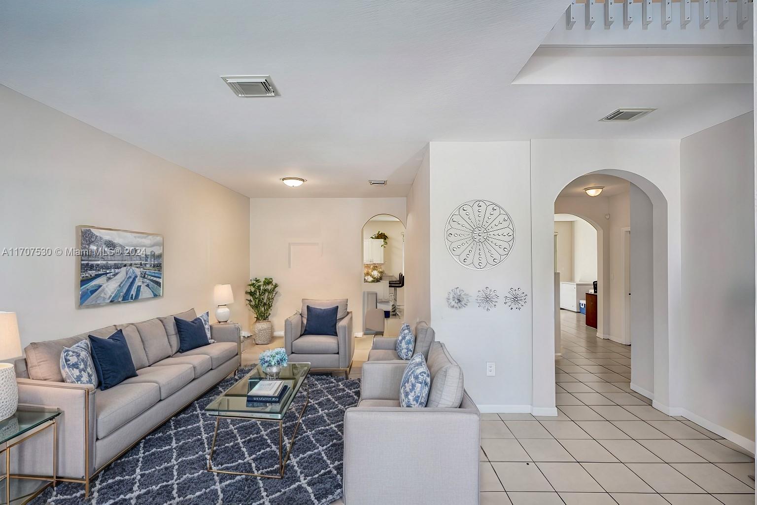 11763 Southwest 137th Path Miami, FL 33186 - Photo 4 of 27 a living room with furniture and a clock