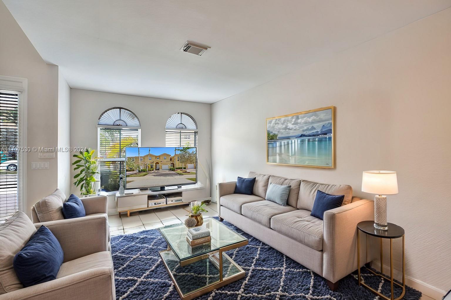 11763 Southwest 137th Path Miami, FL 33186 - Photo 5 of 27 a living room with furniture and a flat screen tv