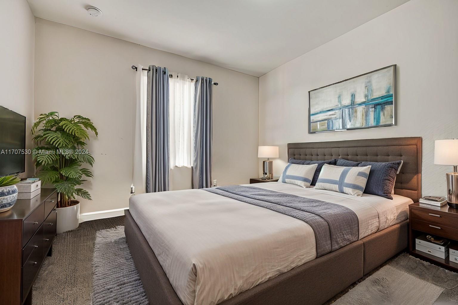 11763 Southwest 137th Path Miami, FL 33186 - Photo 7 of 27 a bedroom with a bed and a potted plant