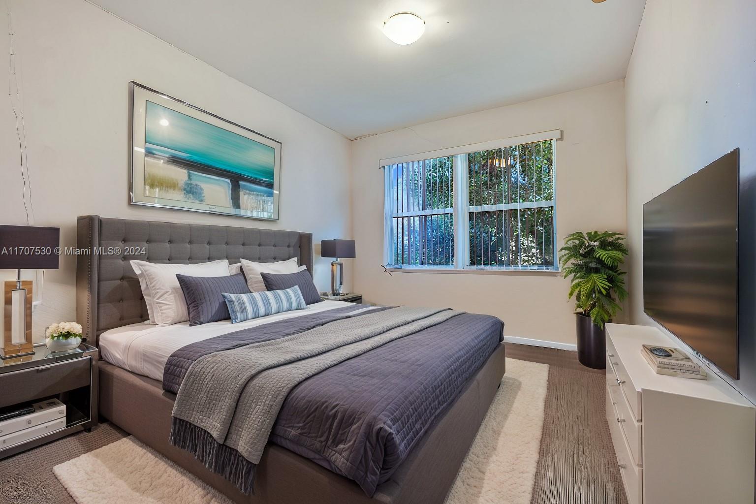 11763 Southwest 137th Path Miami, FL 33186 - Photo 9 of 27 a bedroom with bed tv and window