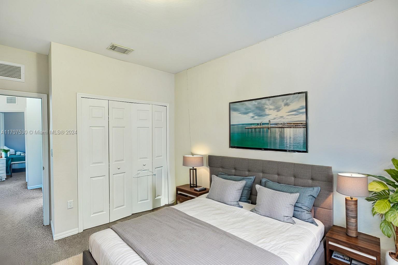 11763 Southwest 137th Path Miami, FL 33186 - Photo 10 of 27 a bedroom with a bed and a painting on the wall