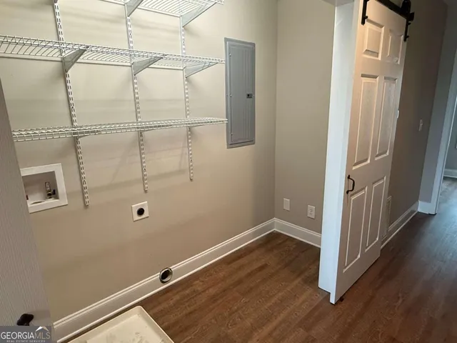 a view of a room with wooden floor