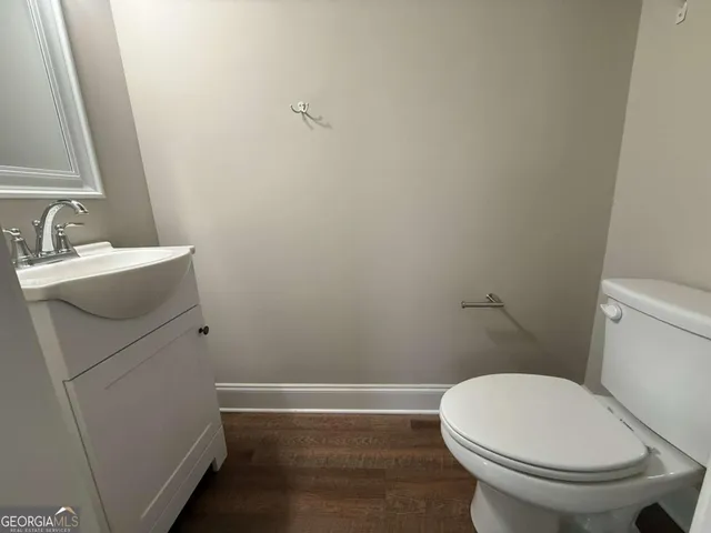 a white toilet sitting next to a bathroom sink