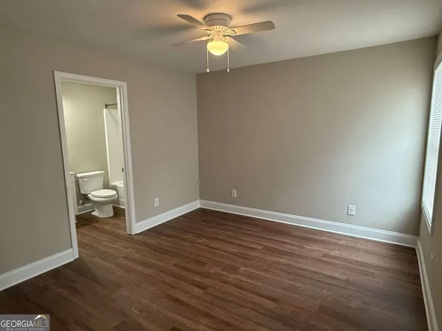 a view of an empty room and wooden floor