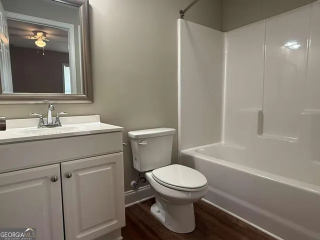 a bathroom with a toilet a sink and bathtub