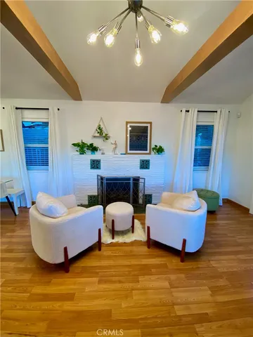 a living room with furniture and a pool table