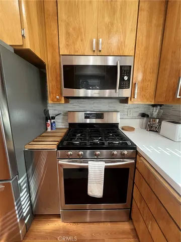 a stove top oven sitting inside of a kitchen