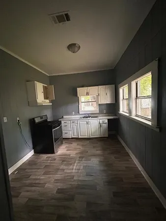 a view of a kitchen with granite countertop cabinets and a window