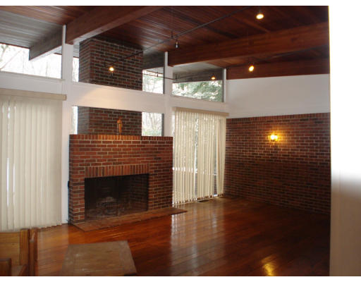 6 Stonewall Road Lexington, MA 02421 - Photo 3 of 10 a view of an empty room with wooden floor and a fireplace