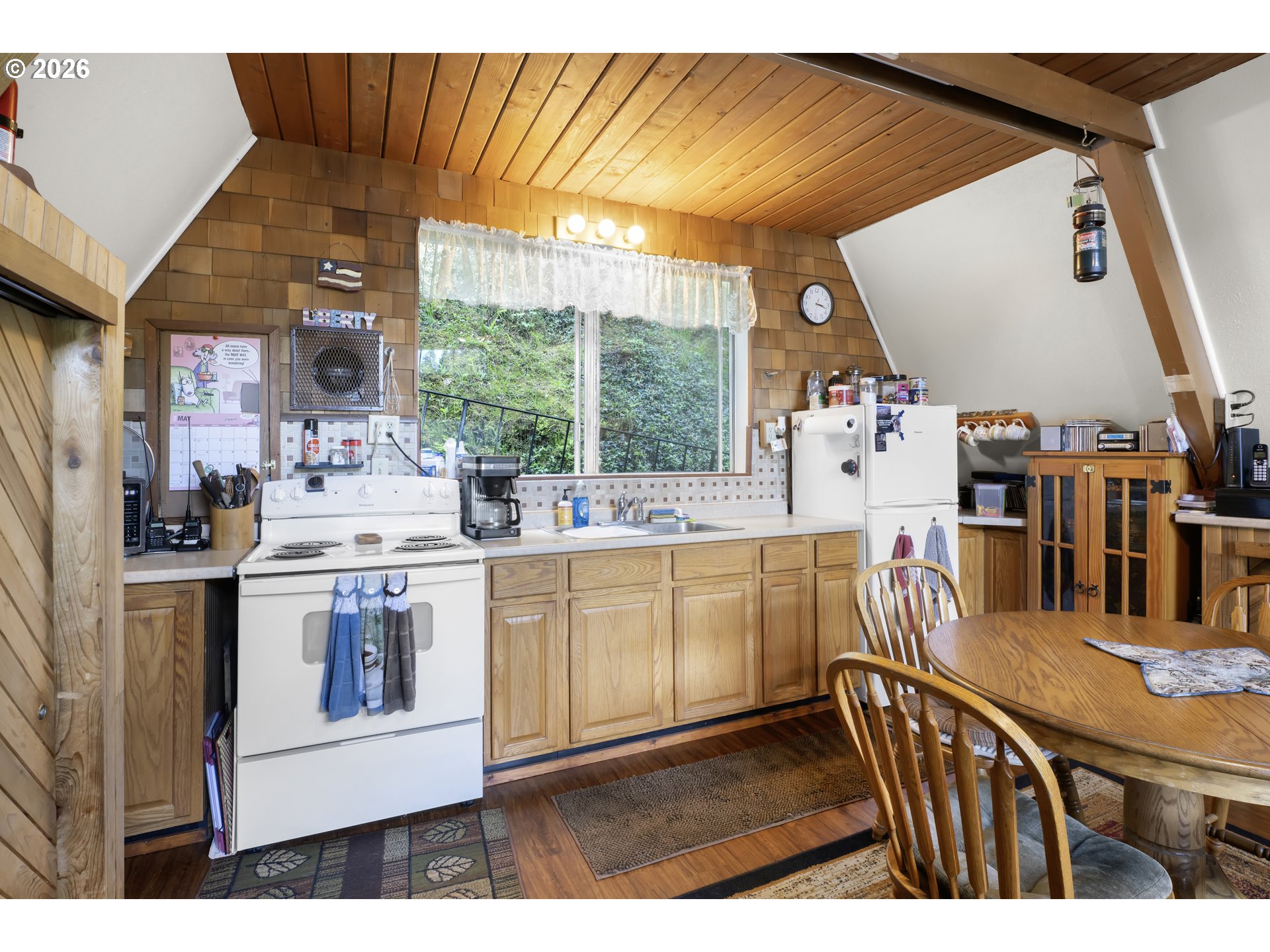1901 Loon Lake Road Reedsport, OR 97467 - Photo 14 of 24 a kitchen with stainless steel appliances granite countertop a stove and white cabinets