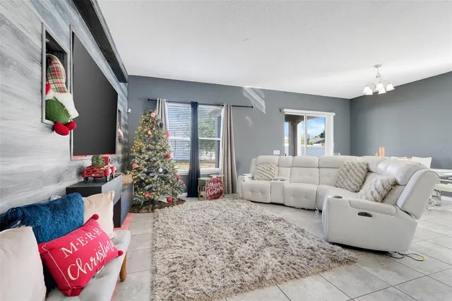 a living room with furniture and kitchen view