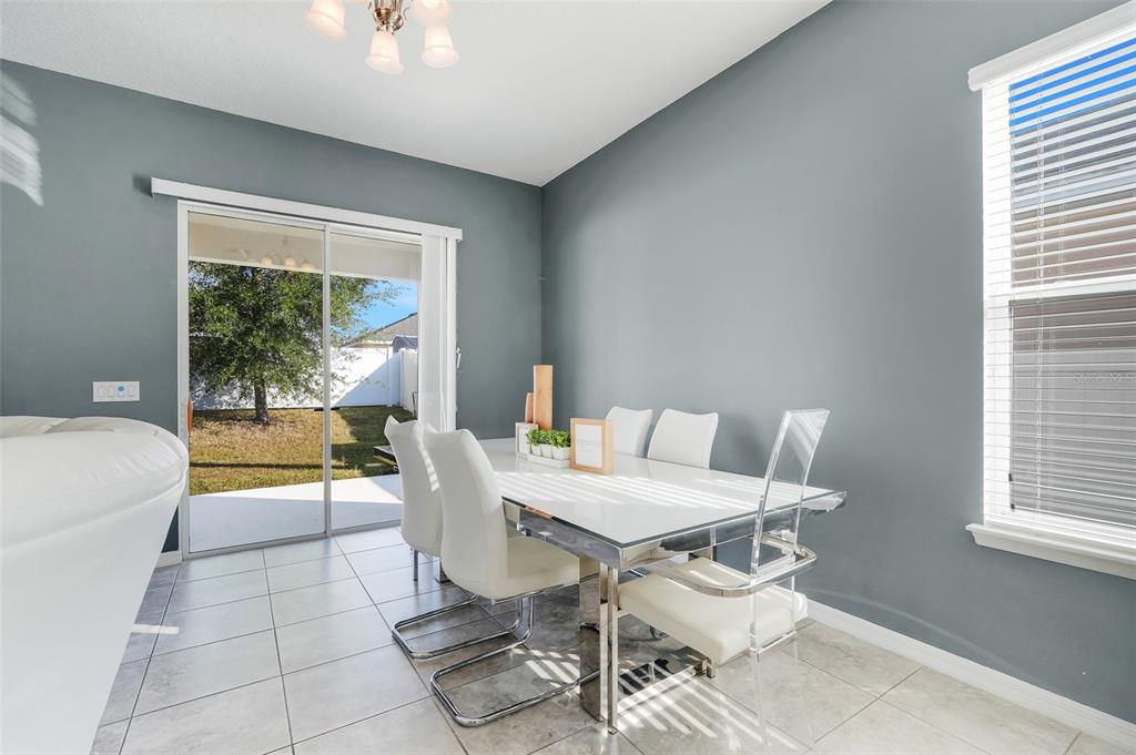 1807 Sunfish Street St. Cloud, FL 34771 - Photo 14 of 27 a dining room with furniture and a large window