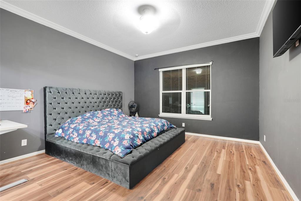 1807 Sunfish Street St. Cloud, FL 34771 - Photo 15 of 27 a bed sitting in a bedroom next to a window