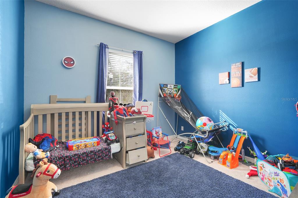 1807 Sunfish Street St. Cloud, FL 34771 - Photo 22 of 27 a bedroom with toys and a baby crib