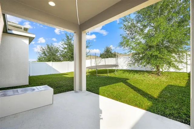 a view of backyard with swimming pool