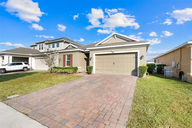 a front view of a house with a yard and garage