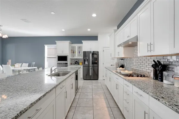a kitchen with a refrigerator stove and cabinets