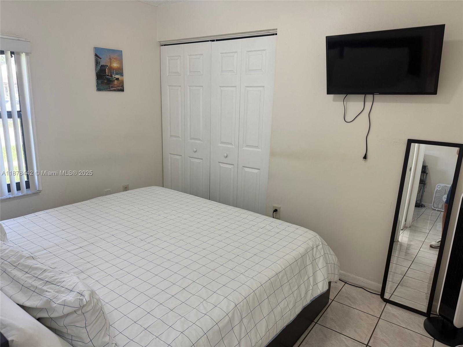 4929 Southwest 139th Court Miami, FL 33175 - Photo 12 of 27 a bedroom with a bed and a flat screen tv
