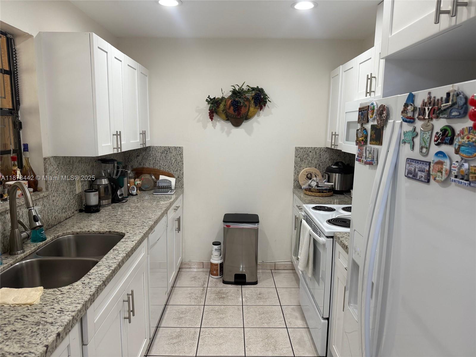 4929 Southwest 139th Court Miami, FL 33175 - Photo 13 of 27 a kitchen with a sink and a stove top oven