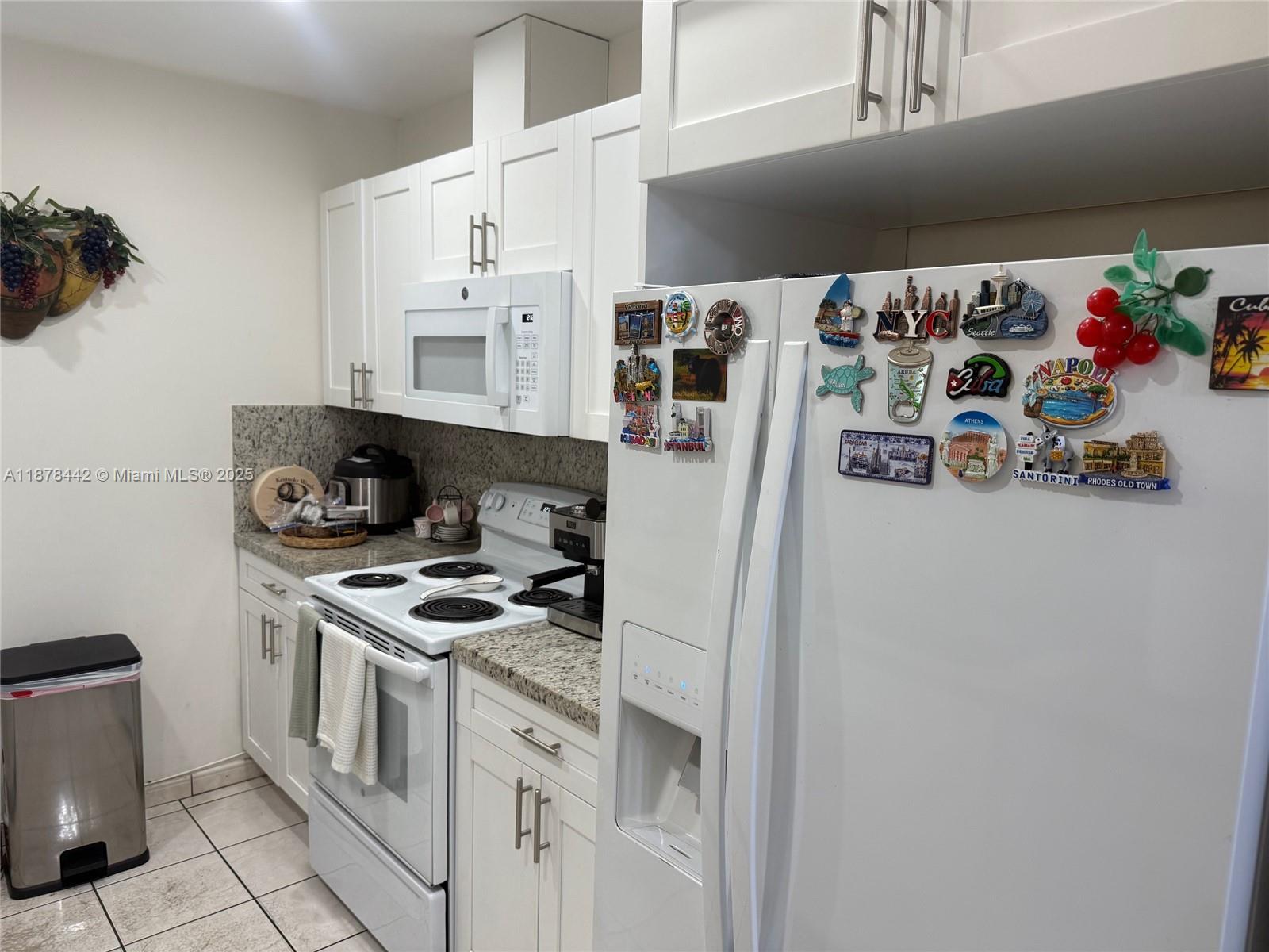4929 Southwest 139th Court Miami, FL 33175 - Photo 15 of 27 a kitchen with stainless steel appliances granite countertop a stove and a refrigerator