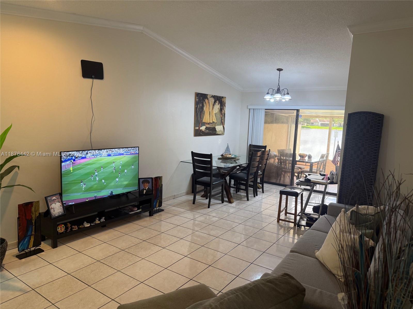 4929 Southwest 139th Court Miami, FL 33175 - Photo 16 of 27 a living room with furniture a flat screen tv and a large window