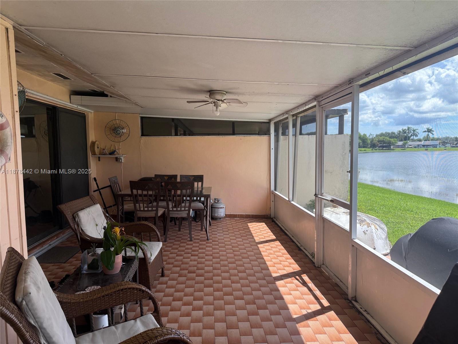 4929 Southwest 139th Court Miami, FL 33175 - Photo 19 of 27 a view of a chairs and table in patio with a lake view