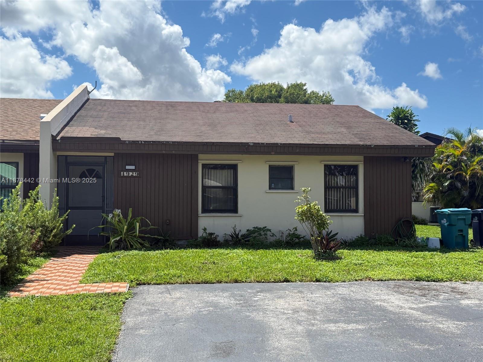 4929 Southwest 139th Court Miami, FL 33175 - Photo 3 of 27 a front view of a house with a garden and plants