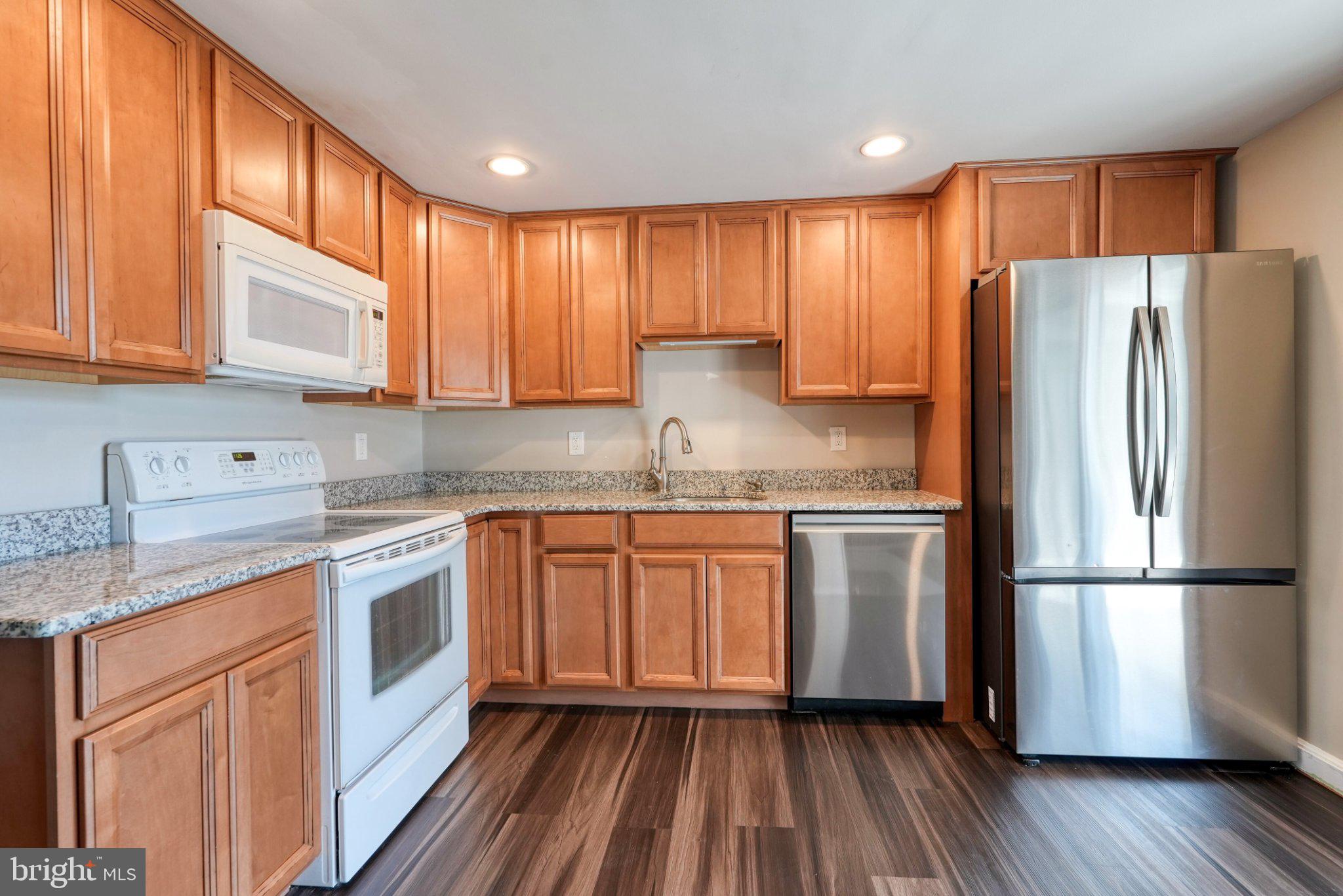 2512 Grandview Road Coatesville, PA 19320 - Photo 23 of 51 a kitchen with granite countertop stainless steel appliances a refrigerator sink and cabinets