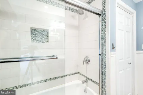 a bathroom with a shower and a bath tub
