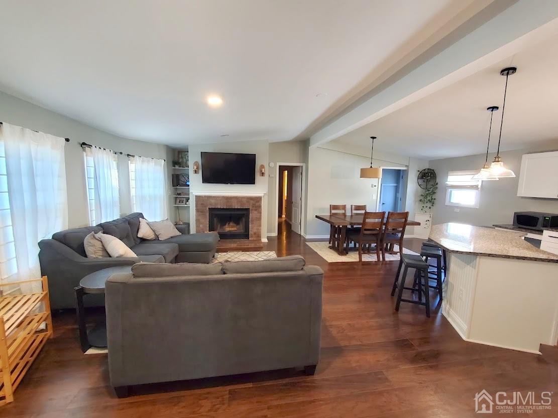 39 Poe Road North Brunswick, NJ 08902 - Photo 3 of 22 a living room with furniture a fireplace and a flat screen tv