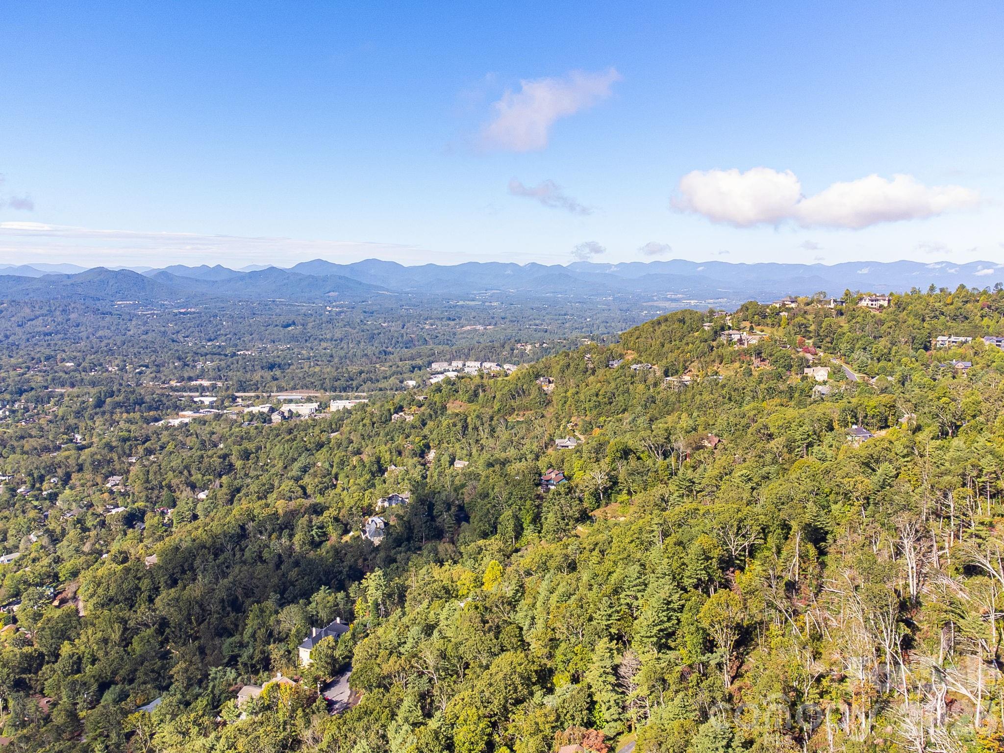 99999 Beaverbrook Road, Unit 2 Asheville, NC 28804 - Photo 16 of 33 a view of a city with mountains in the background