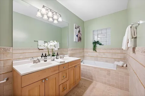 a bath room with a sink and a mirror