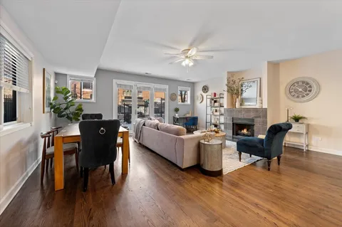a living room with fireplace furniture and a wooden floor