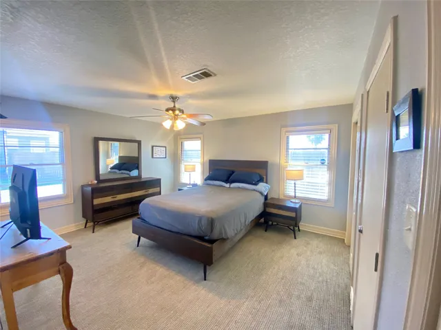 a bedroom with bed and a chandelier