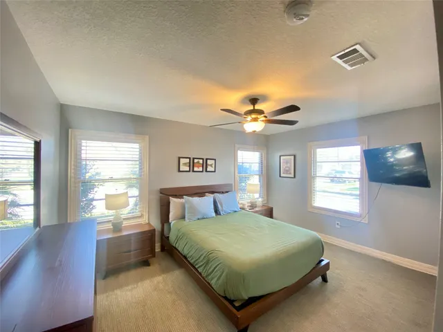 a bedroom with a large bed and a window