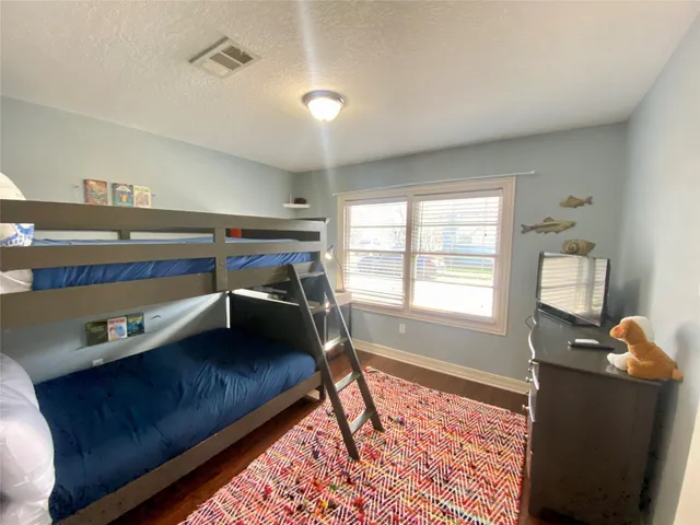 a bedroom with furniture and a window