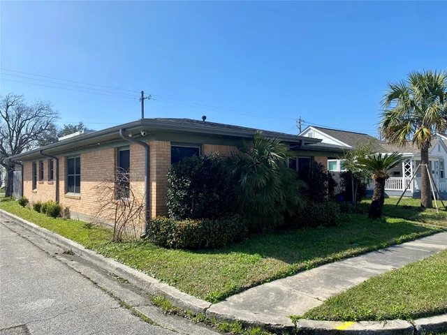 a front view of house with a garden