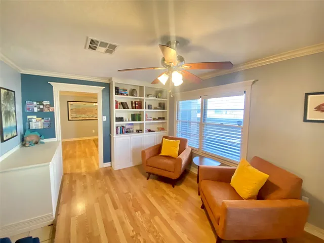 a living room with furniture and wooden floor