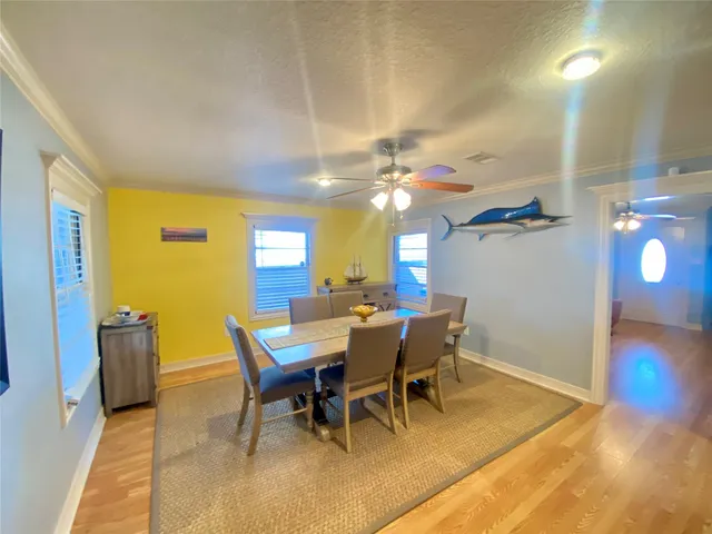 a view of a dining room with furniture and wooden floor