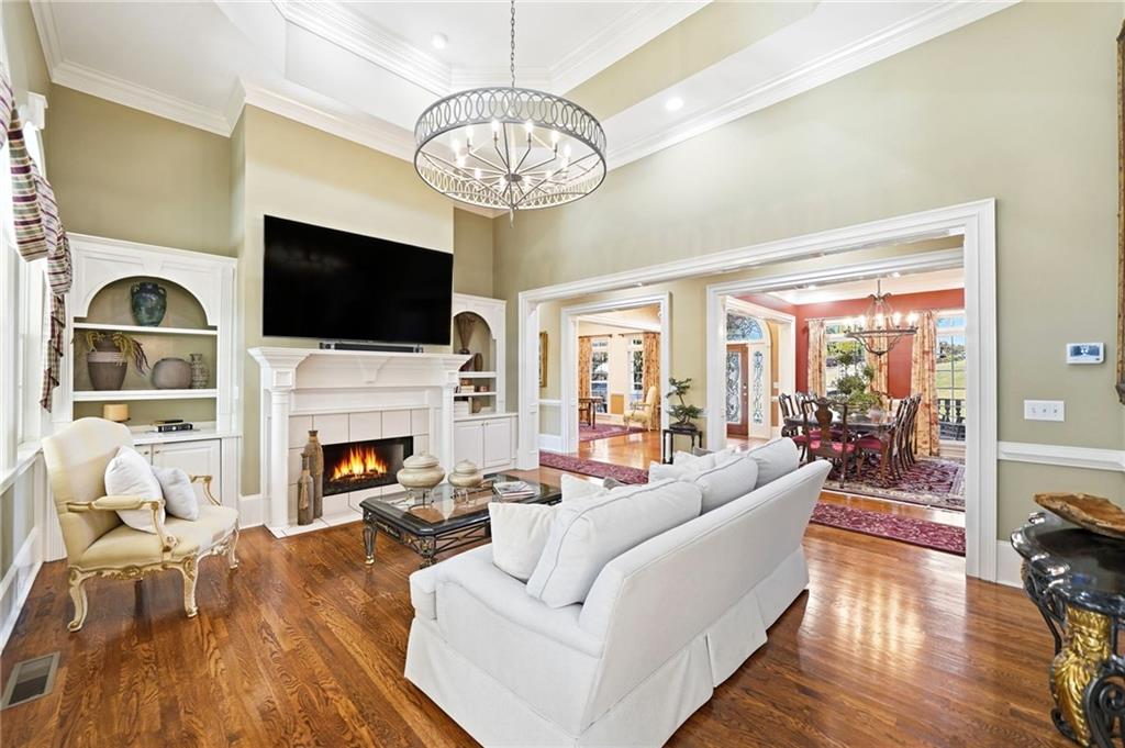 2855 Strathmore Drive Cumming, GA 30041 - Photo 15 of 96 a living room with furniture a fireplace and a flat screen tv