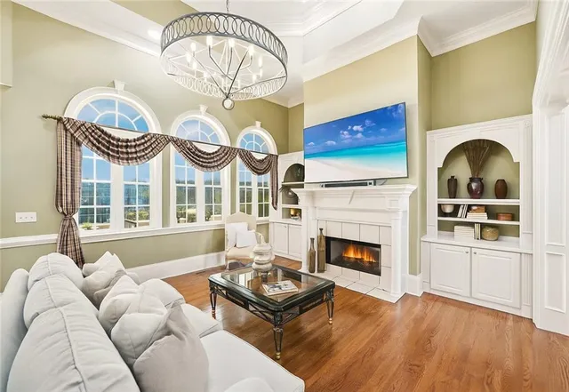 a kitchen with white cabinets and chandelier