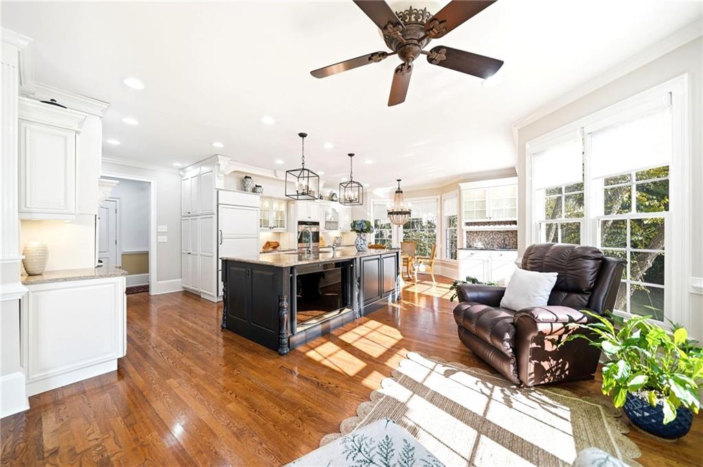 2855 Strathmore Drive Cumming, GA 30041 - Photo 19 of 96 a living room with kitchen island furniture and a chandelier